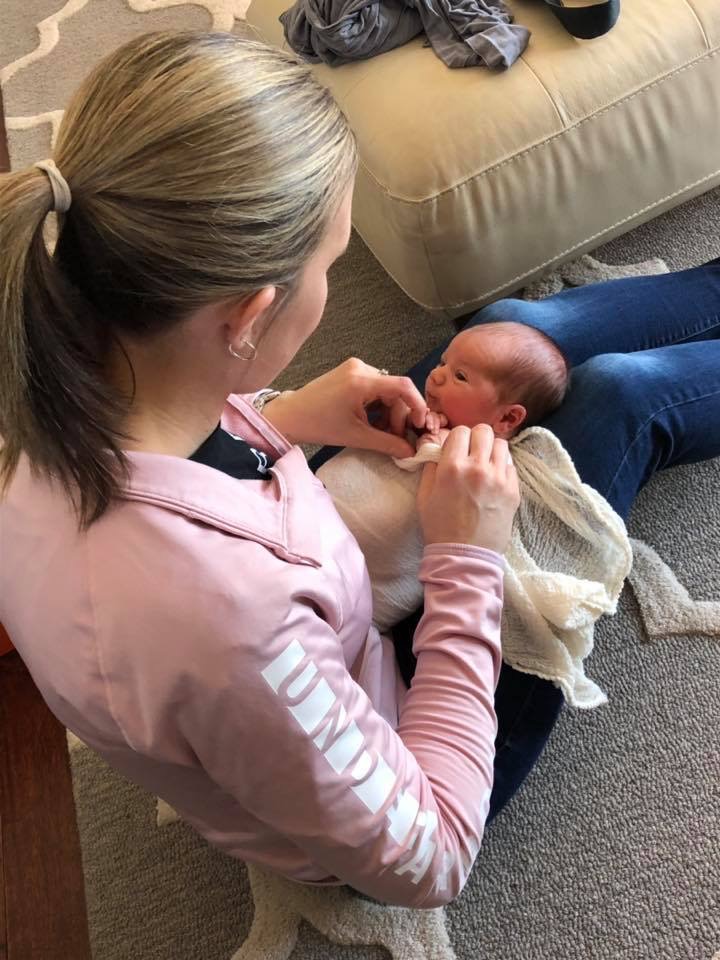 Ohio Newborn Photographer swadding a baby - Stacey Ash