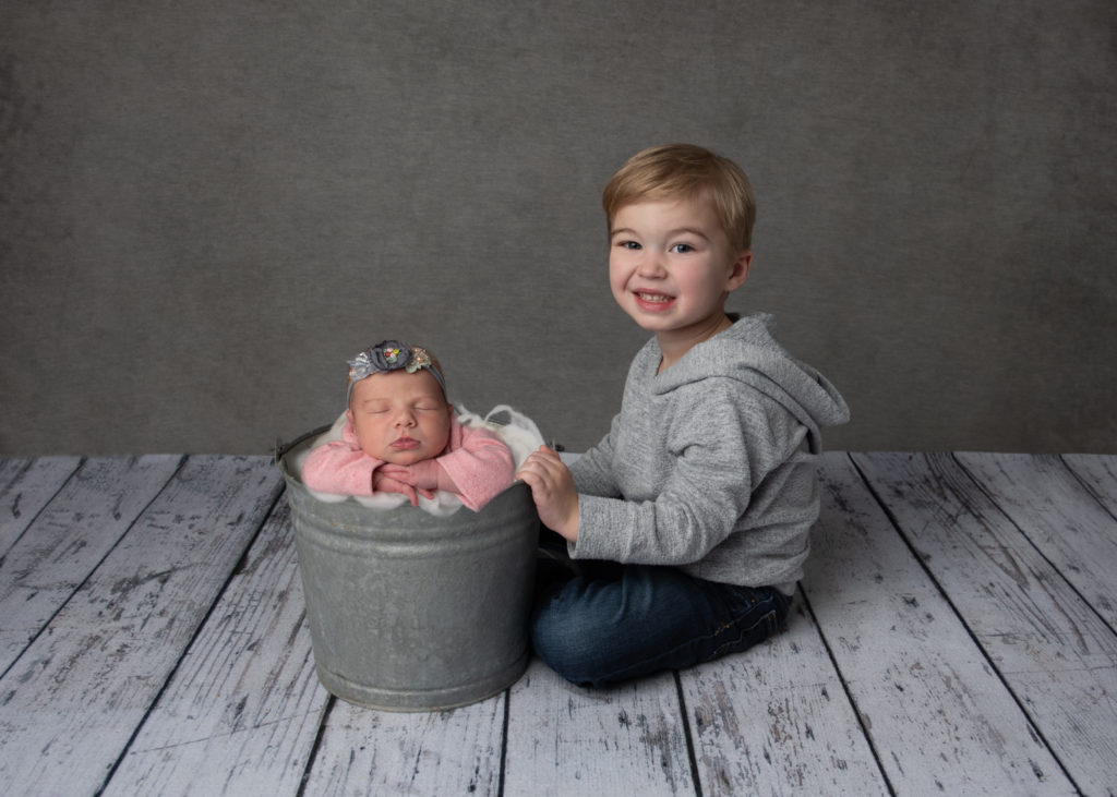 brother with baby in a bucket