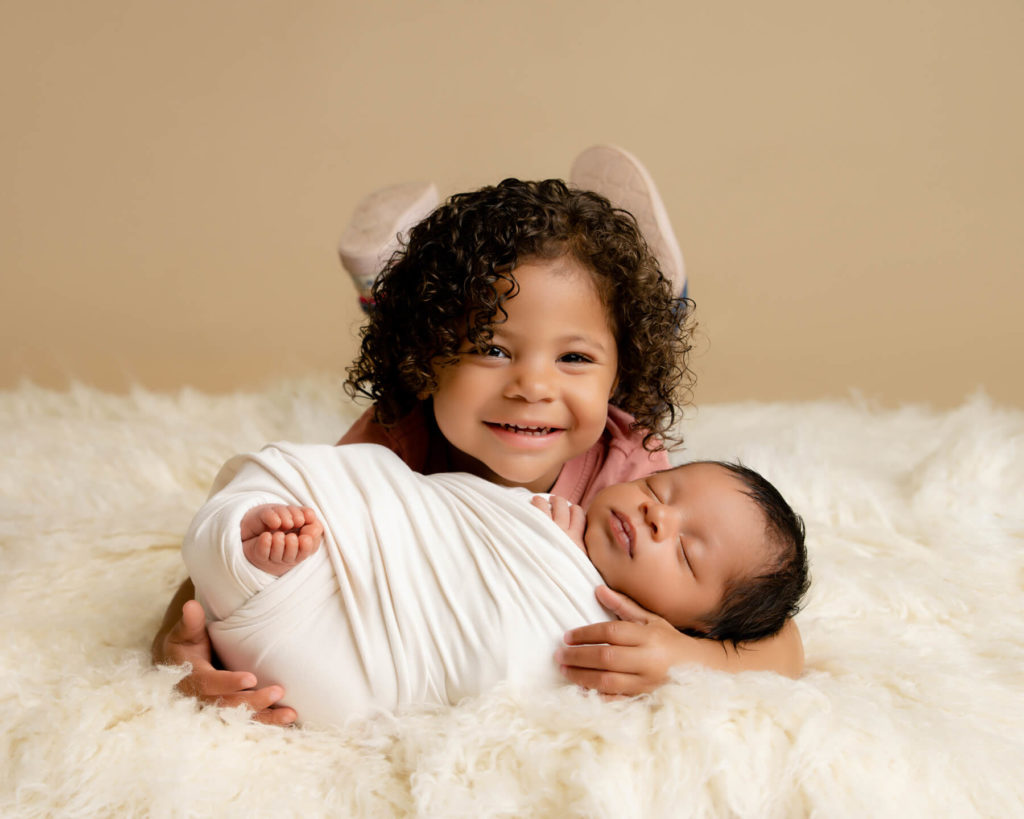 happy child with baby brother at a photo session