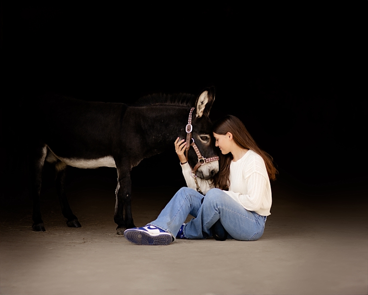 teenage girl with her mini donkey